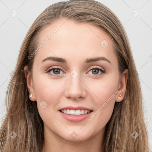 Joyful white young-adult female with long  brown hair and grey eyes