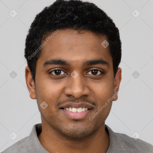 Joyful black young-adult male with short  black hair and brown eyes