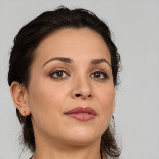 Joyful white adult female with medium  brown hair and brown eyes