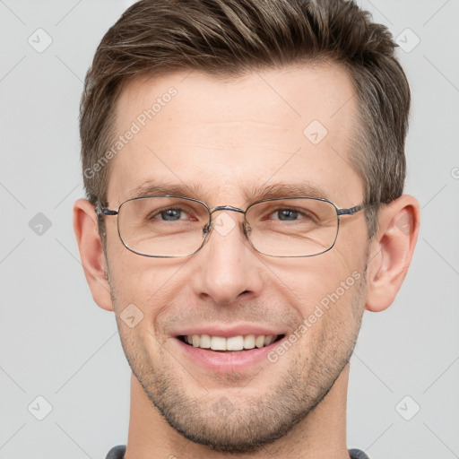 Joyful white adult male with short  brown hair and grey eyes