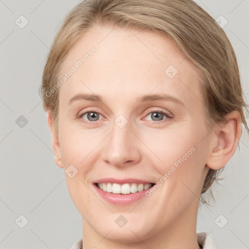 Joyful white young-adult female with medium  brown hair and blue eyes