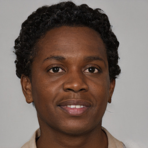 Joyful black young-adult male with short  brown hair and brown eyes