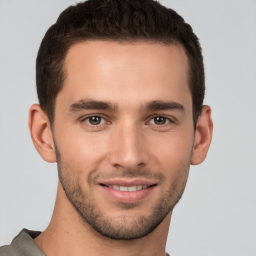 Joyful white young-adult male with short  brown hair and brown eyes