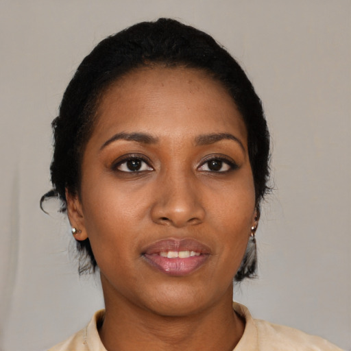 Joyful black young-adult female with medium  black hair and brown eyes