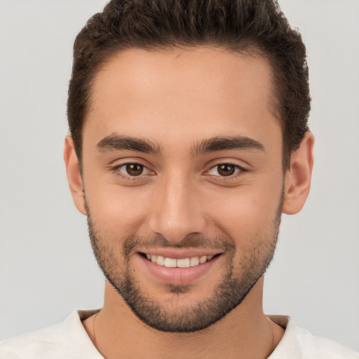 Joyful white young-adult male with short  brown hair and brown eyes