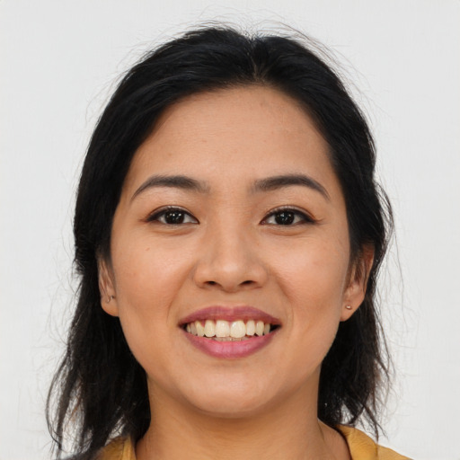 Joyful asian young-adult female with long  brown hair and brown eyes