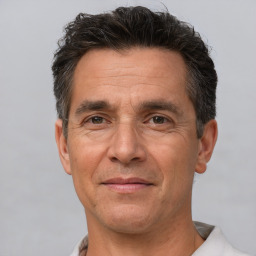 Joyful white middle-aged male with short  brown hair and brown eyes