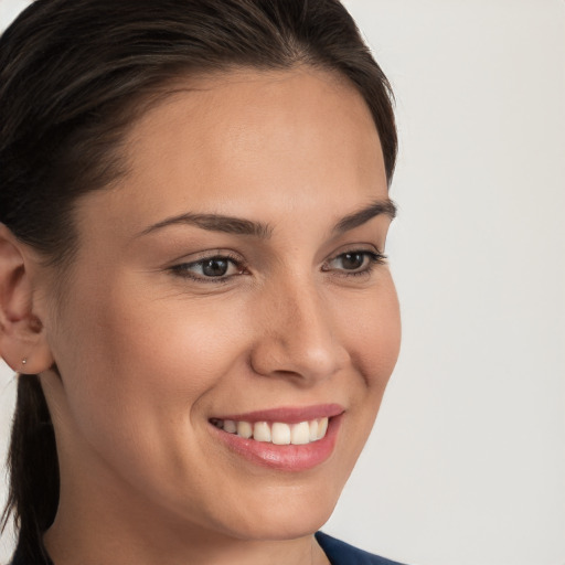 Joyful white young-adult female with medium  brown hair and brown eyes