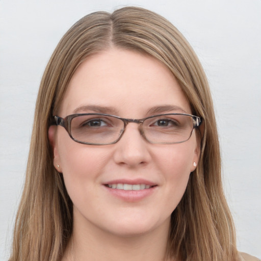 Joyful white young-adult female with long  brown hair and blue eyes