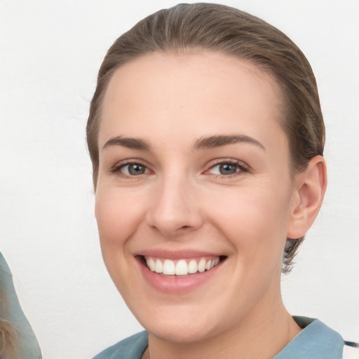 Joyful white young-adult female with short  brown hair and grey eyes