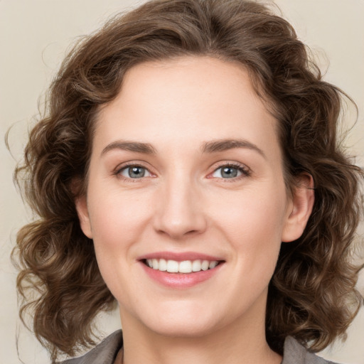 Joyful white young-adult female with medium  brown hair and green eyes