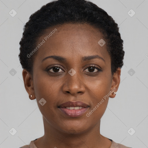 Joyful black young-adult female with short  brown hair and brown eyes