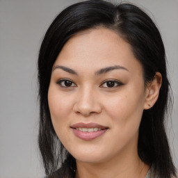 Joyful asian young-adult female with long  brown hair and brown eyes