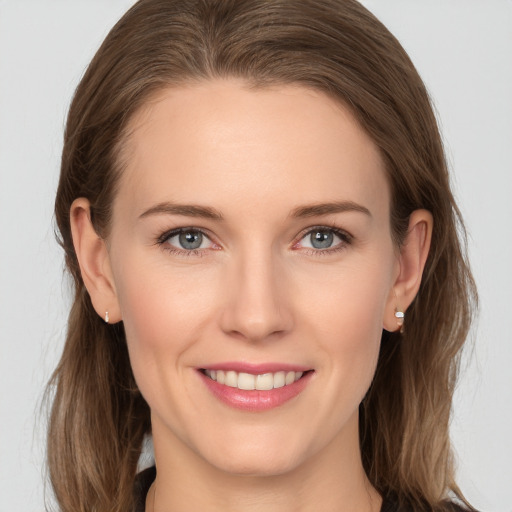 Joyful white young-adult female with long  brown hair and grey eyes