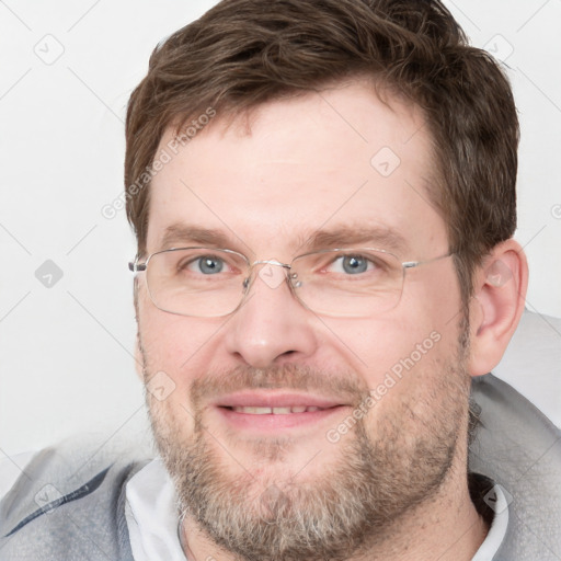 Joyful white adult male with short  brown hair and grey eyes