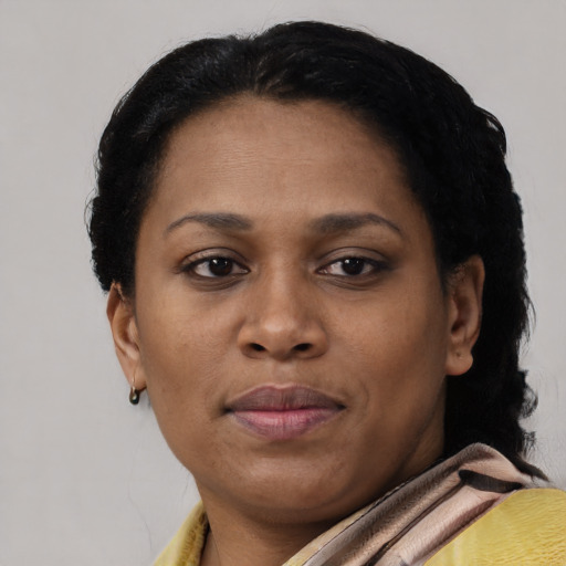 Joyful black adult female with short  brown hair and brown eyes