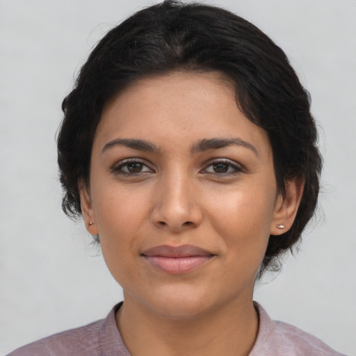 Joyful latino young-adult female with short  brown hair and brown eyes