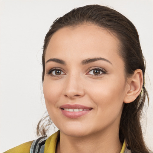 Joyful white young-adult female with long  brown hair and brown eyes