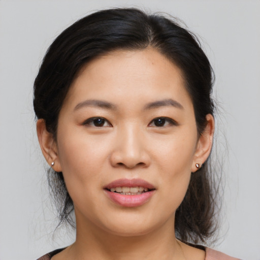 Joyful asian young-adult female with medium  brown hair and brown eyes