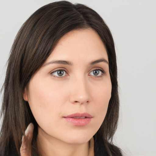 Neutral white young-adult female with long  brown hair and brown eyes