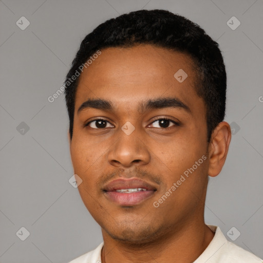 Joyful black young-adult male with short  black hair and brown eyes