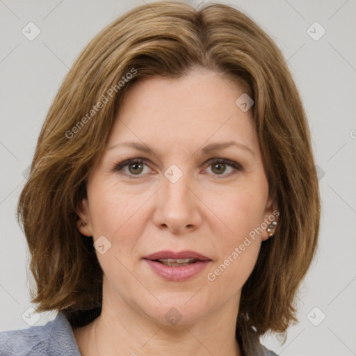 Joyful white adult female with medium  brown hair and green eyes