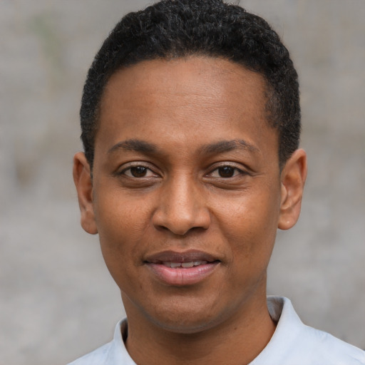 Joyful black young-adult male with short  black hair and brown eyes