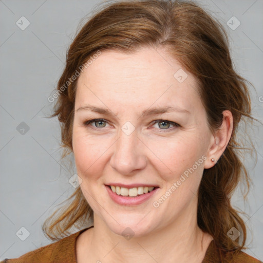 Joyful white adult female with medium  brown hair and blue eyes