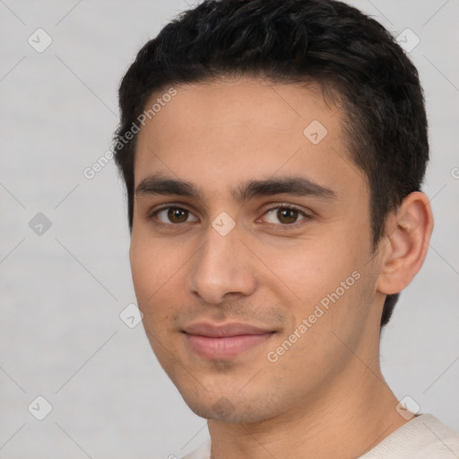 Joyful white young-adult male with short  black hair and brown eyes