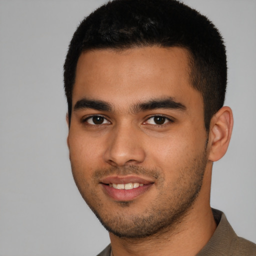 Joyful latino young-adult male with short  black hair and brown eyes