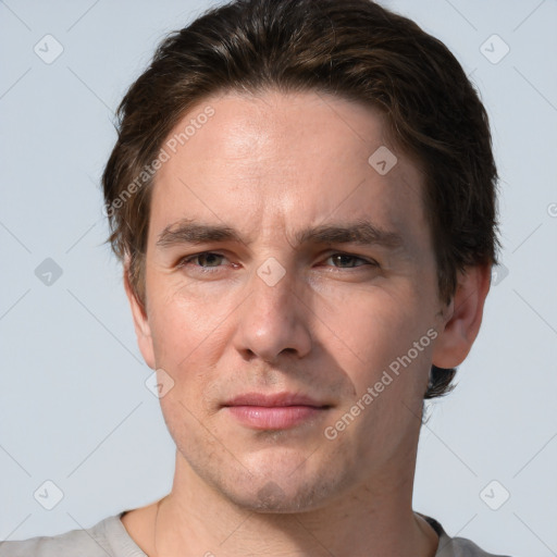 Joyful white adult male with short  brown hair and grey eyes