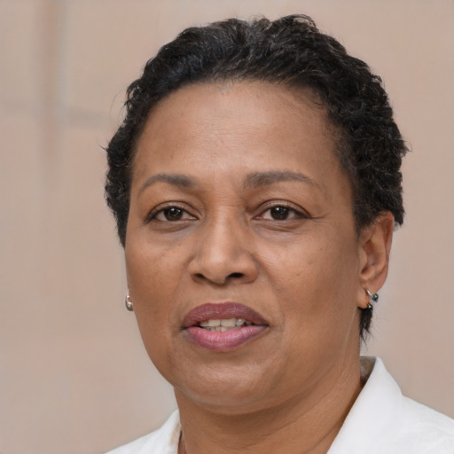 Joyful black adult female with short  brown hair and brown eyes