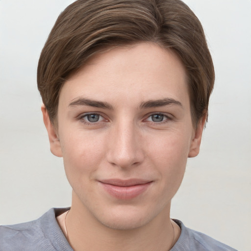 Joyful white young-adult female with short  brown hair and grey eyes