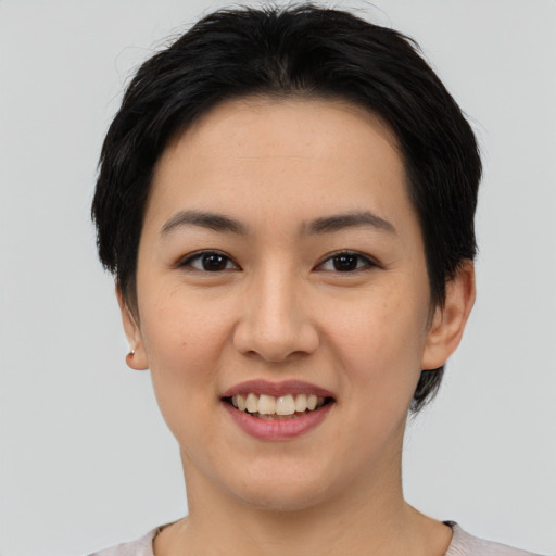Joyful asian young-adult female with short  black hair and brown eyes