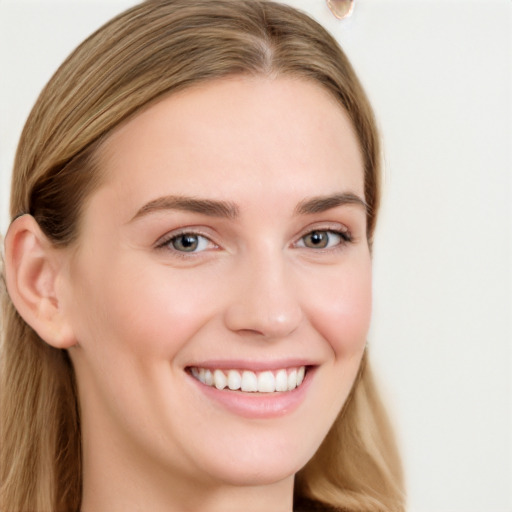 Joyful white young-adult female with long  brown hair and blue eyes