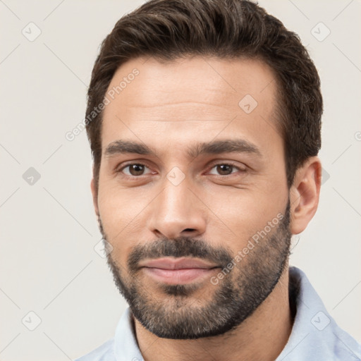 Joyful white young-adult male with short  brown hair and brown eyes