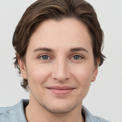 Joyful white young-adult female with short  brown hair and grey eyes