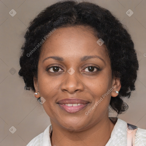 Joyful black adult female with medium  brown hair and brown eyes