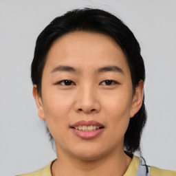 Joyful asian young-adult female with short  black hair and brown eyes