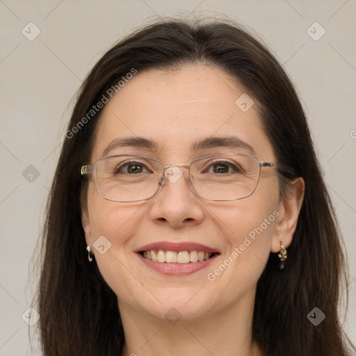 Joyful white adult female with long  brown hair and brown eyes