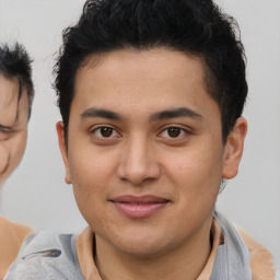 Joyful latino young-adult male with short  brown hair and brown eyes