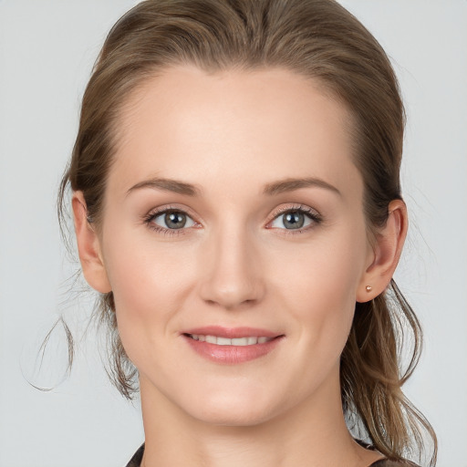 Joyful white young-adult female with medium  brown hair and blue eyes