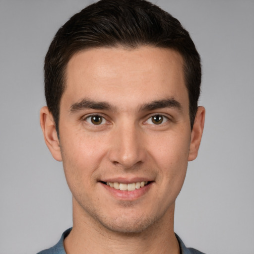 Joyful white young-adult male with short  brown hair and brown eyes