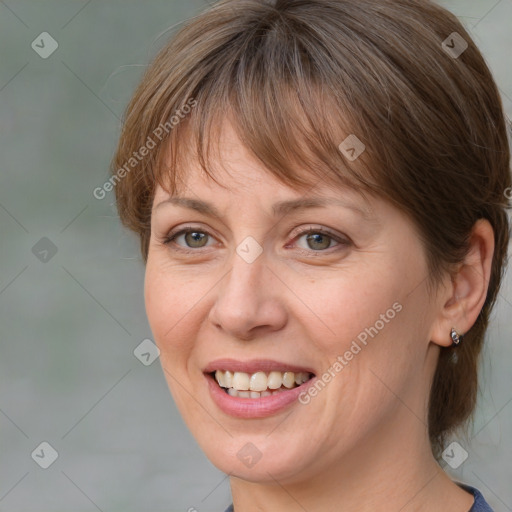 Joyful white adult female with medium  brown hair and blue eyes