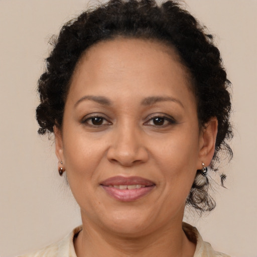 Joyful latino adult female with short  brown hair and brown eyes