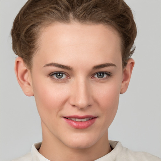 Joyful white young-adult female with short  brown hair and grey eyes