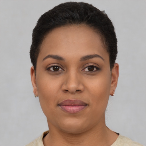 Joyful black young-adult female with short  brown hair and brown eyes