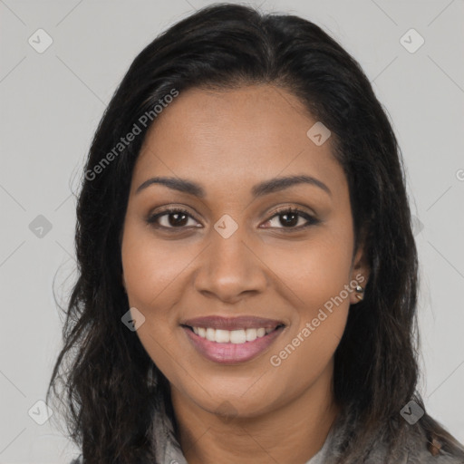 Joyful black young-adult female with long  brown hair and brown eyes