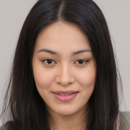 Joyful asian young-adult female with long  brown hair and brown eyes