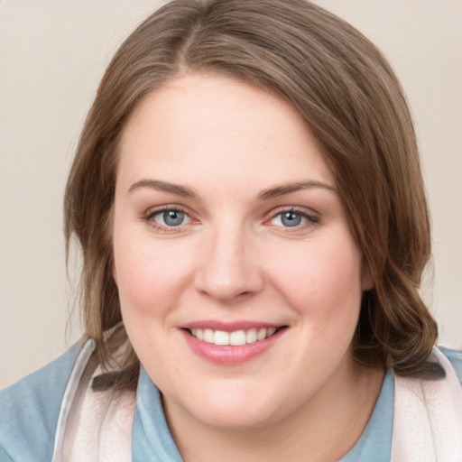 Joyful white young-adult female with medium  brown hair and blue eyes